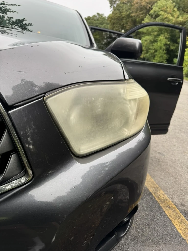 Cloudy, yellowed headlight lens before restoration